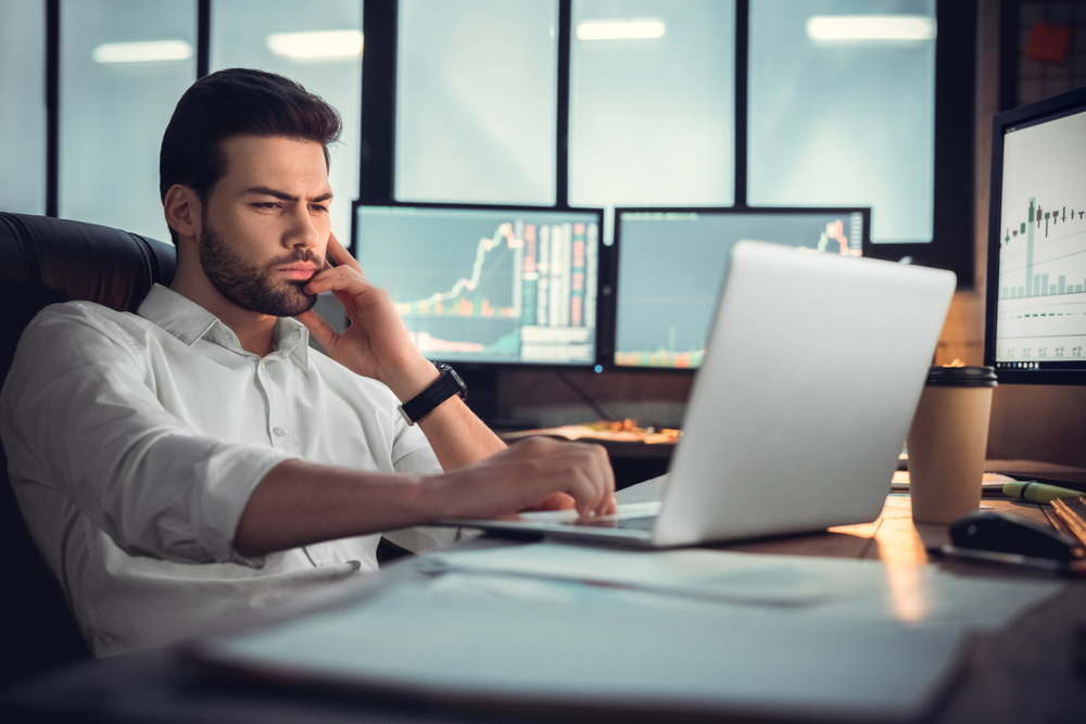 Young,Male,Trader,At,Office,Work,Concept,Sitting,Browsing,Internet - Tokenhell