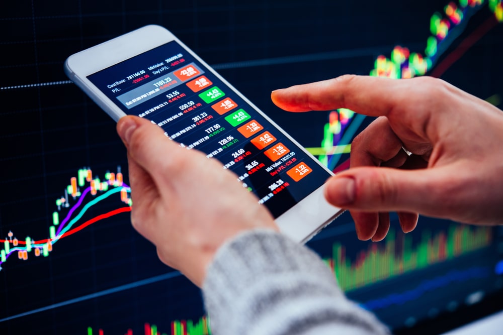 ATraderOrAFinancialAnalystCheckingTheRecentStock - Tokenhell Lemintero Review – Is Lemintero Scam or Legit? (Complete Lemintero.com review)