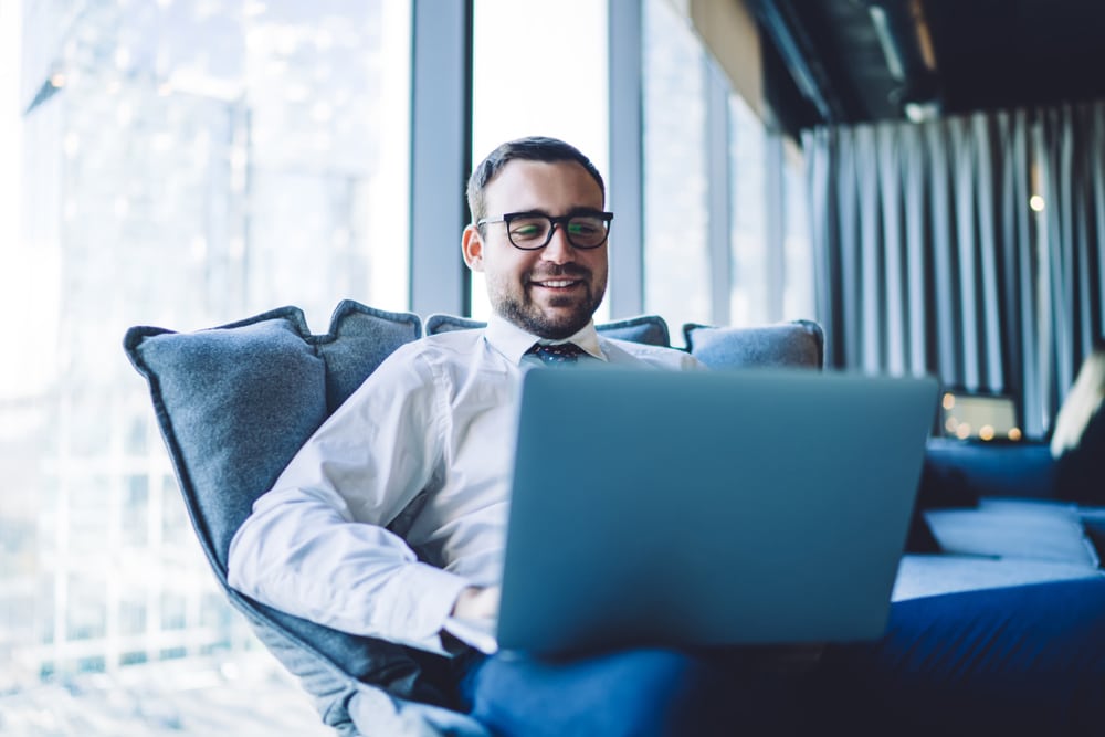 Happy,Smiling,Businessman,Having,Online,Conference,Via,Laptop,Computer,Sitting - Tokenhell