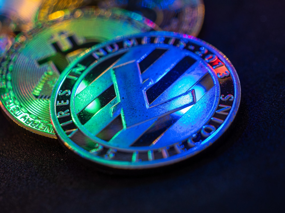 Litecoin,Laying,On,Dark,Table,With,Beautiful,Colourful,Reflections,In - Tokenhell