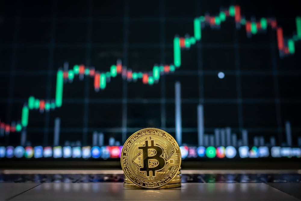 ASinglePhysicalGoldenBitcoinInFrontOfAScreen - Tokenhell Beyond MicroStrategy: Six More Publicly Traded Firms That Hold Bitcoin
