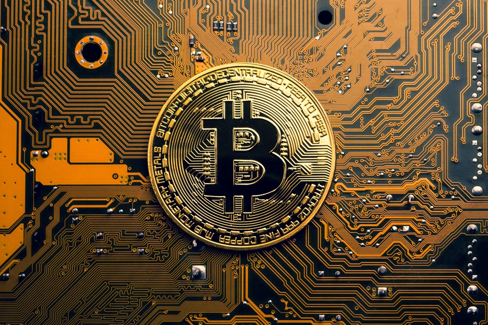 A,Golden,Coin,With,Bitcoin,Symbol,On,A,Mainboard. - Tokenhell