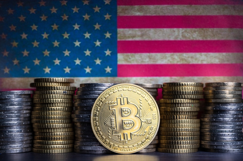 BitcoinTokenInfrontOfCurrencyCoinsAndGrungyFlagOf - Tokenhell US Government Set to Sell $117M in Bitcoin Seized From Convicted Silk Road Drug Trafficker