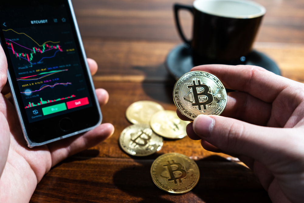 Smartphone,With,Bitcoin,Trading,Chart,On,The,Screen.,Holding,In - Tokenhell