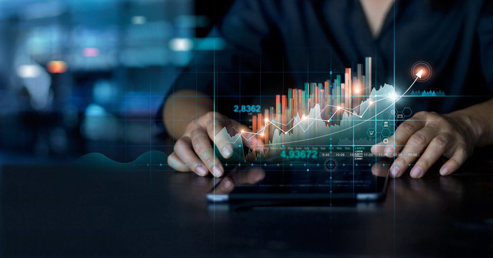 Businessman,Using,Tablet,Analyzing,Sales,Data,And,Economic,Growth,Graph - Tokenhell
