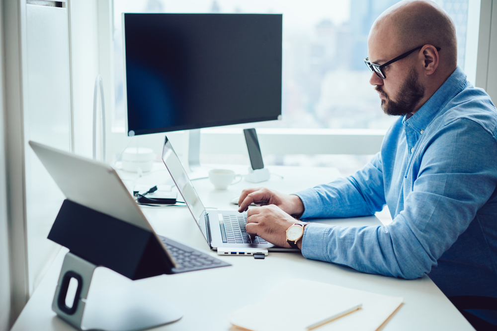 Side,View,Of,Concentrated,Bearded,Male,Employee,In,Formal,Wear - Tokenhell