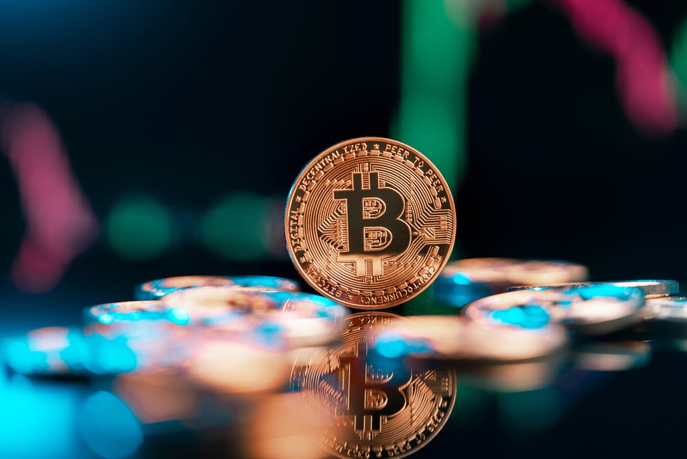 Bitcoin,Cryptocurrency,With,Colorfull,Blurred,Candlestick,Chart,In,The,Background - Tokenhell