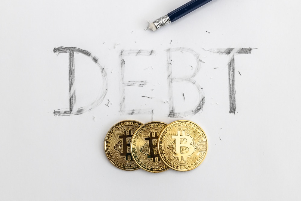 Erasing,Debt,With,Bitcoin.,Debt,Written,On,White,Paper,With - Tokenhell