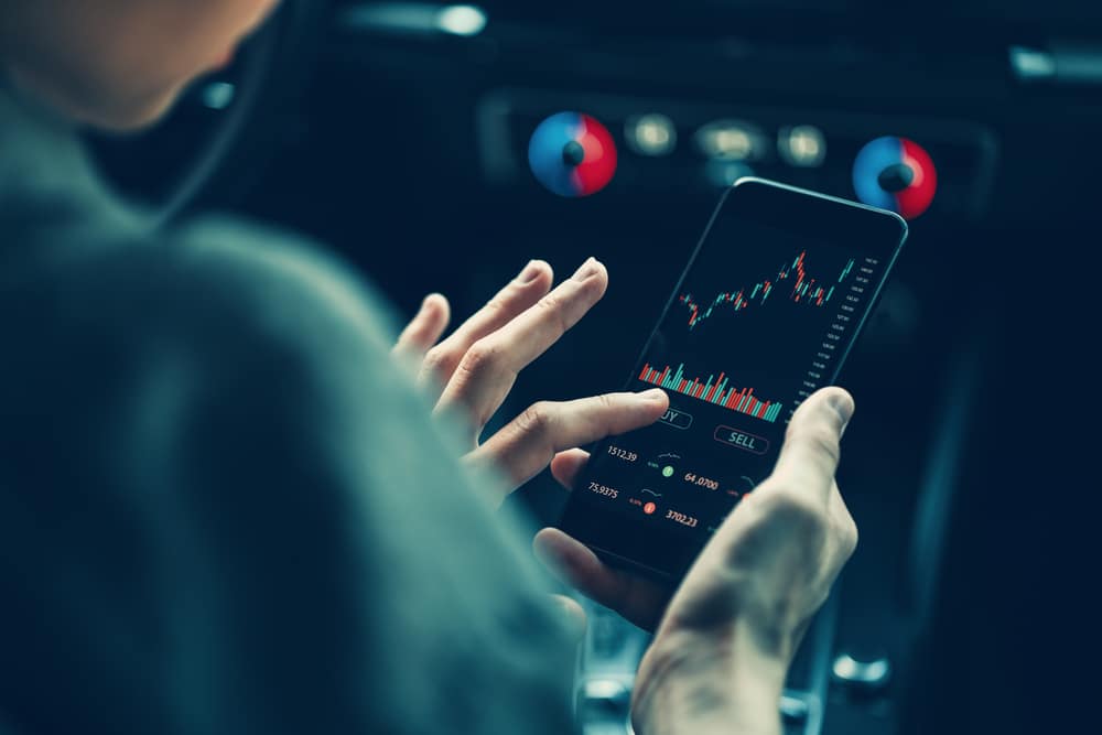 Woman,Touching,Mobile,Phone,Investing,Application,In,Car.,Stock,Market - Tokenhell