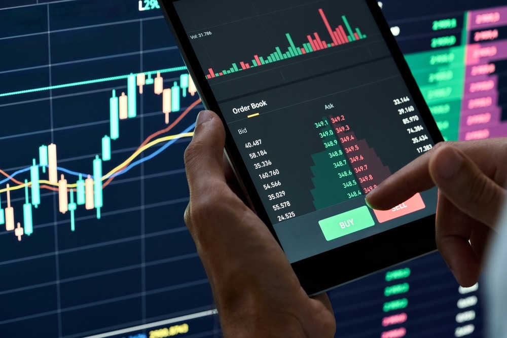 CryptoTraderInvestorBrokerHoldingFingerOnBuyOrSell - Tokenhell Top Crypto Exchanges to Trade Hamster Kombat (HMSTR) - Best Picks for 2024
