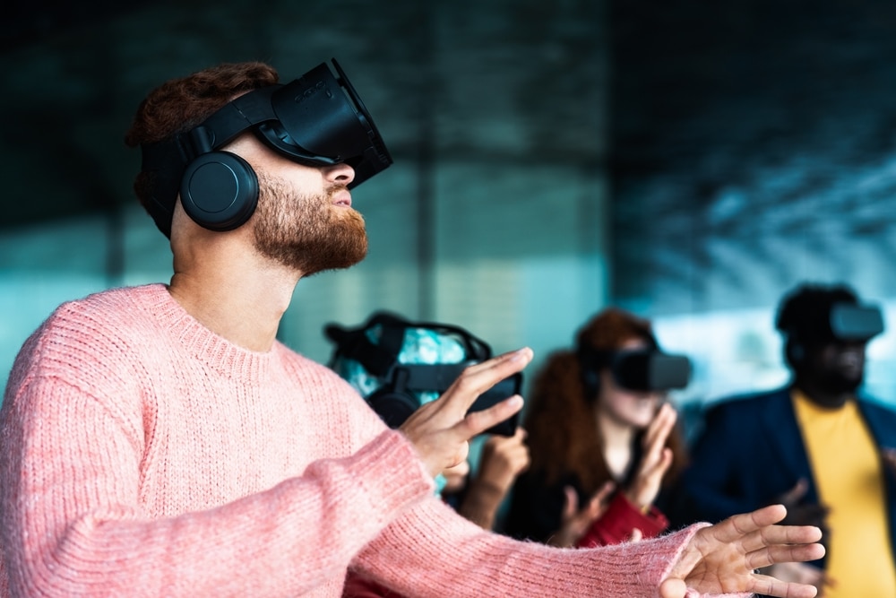 Young,Friends,With,Simulation,Experience,With,Futurist,Virtual,Reality,Glasses - Tokenhell