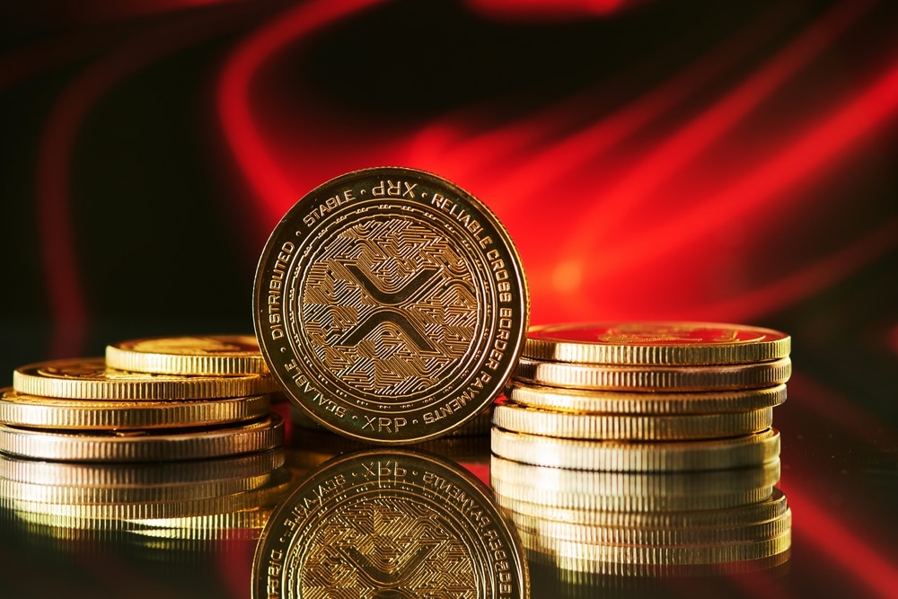 CloseUpOfGoldenRippleXrpCryptocurrencyWithRedAbstract - Tokenhell Investment Analysts Project Delayed Sport XRP ETF