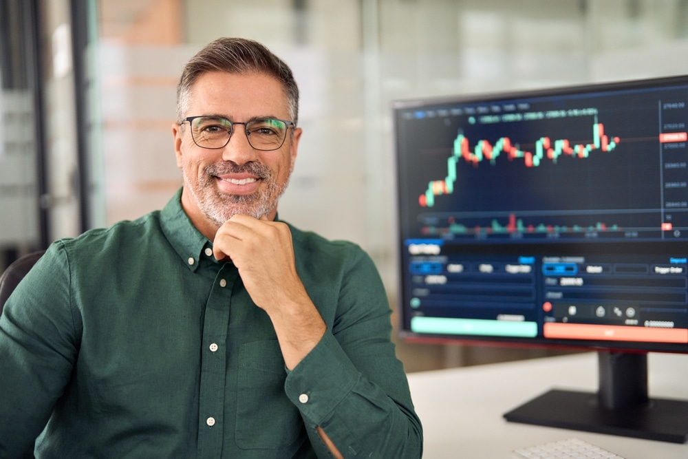 HappyMiddleAgedBusinessManStockInvestorOrBrokerSmiling - Tokenhell Avis sur Market2Trade (Market2Trade.com) - Étendez votre juridiction de trading