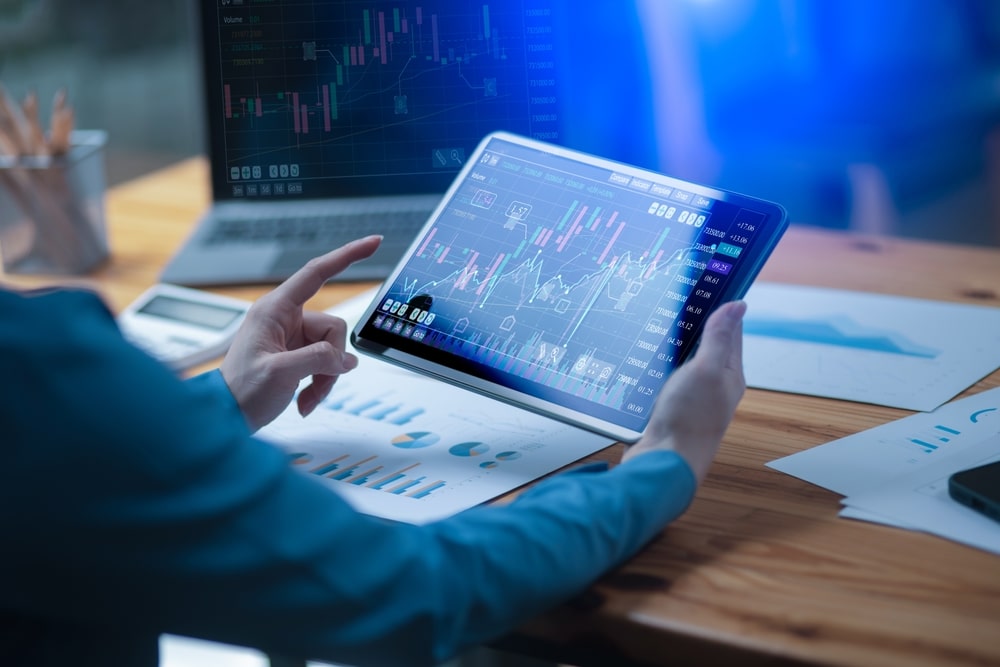 BusinesswomanHandUsingDigitalAndStockMarketOrForexGraph - Tokenhell BitFinancial Bewertung: Eine neue Generation des Krypto-Tradings