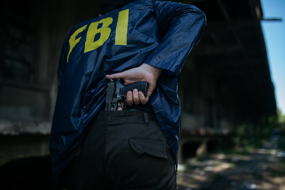 FbiAgentHoldingAGunInHisHandRearView - Tokenhell FBI Arrests' Incognito Market' Owner for Operating Illegal Narcotic Marketplace