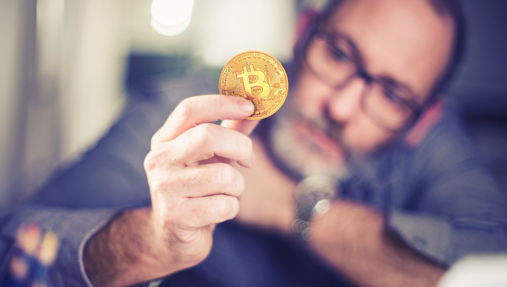 Bitcoins,-,Bitcoin,In,Hand,Of,A,Casual,Businessman,Wondering - Tokenhell