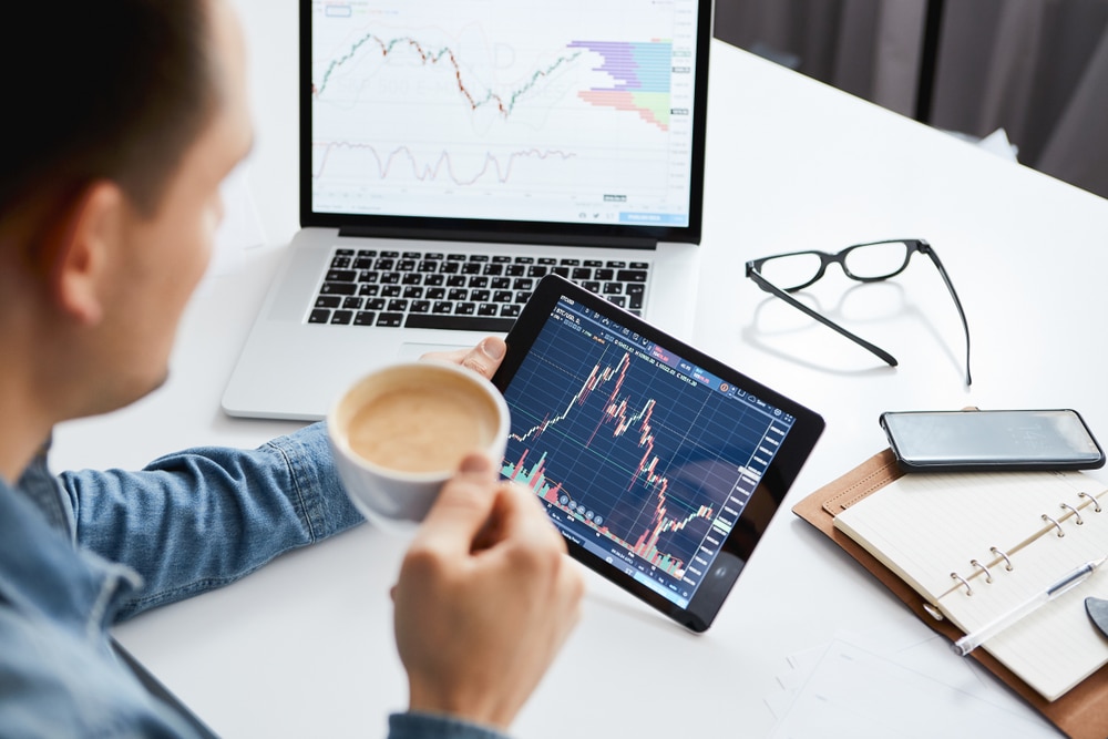 Investor,Watching,The,Change,Of,Stock,Market,On,Tablet. - Tokenhell